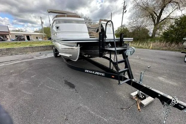 Slide: The Image of 2024 Silver Wave 2610 SW7 JS boat on trailer, parked outdoors under cloudy sky. - 7
