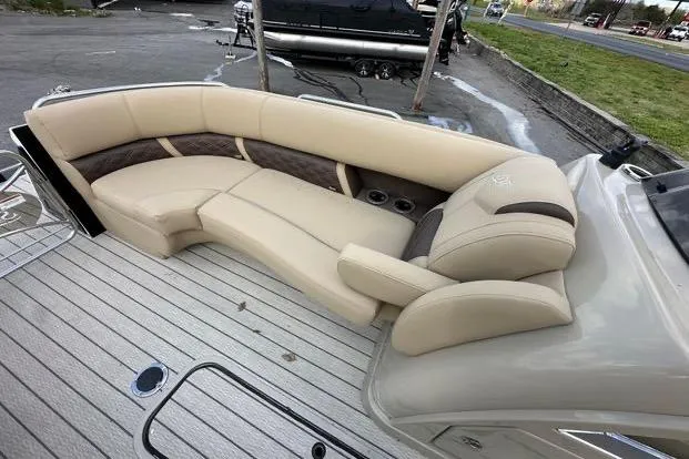 Slide: The Image of 2024 Silver Wave 2610 SW7 JS boat with beige seating and wood deck. - 9
