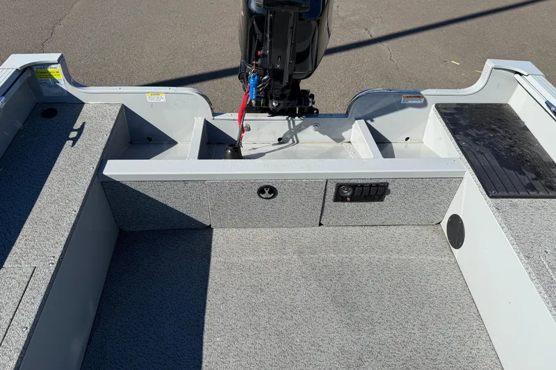 Slide: The Image of 2024 Smoker Craft Freedom 180 TL boat interior with motor and seating area. - 12