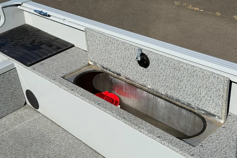 Slide: The Image of 2024 Smoker Craft Freedom 180 TL boat storage compartment with open lid. - 18