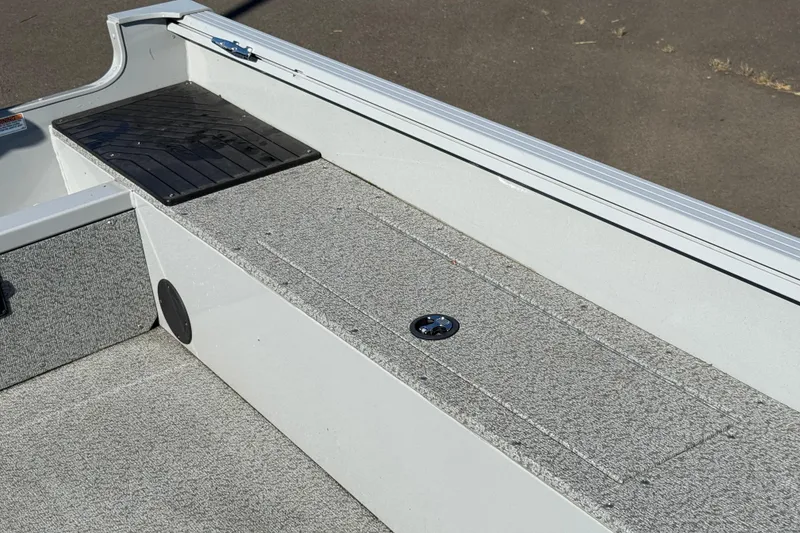 Slide: The Image of 2024 Smoker Craft Freedom 180 TL boat interior with storage compartment and non-slip flooring. - 19