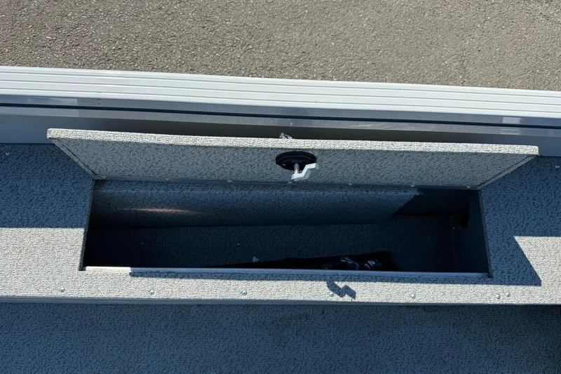 Slide: The Image of 2024 Smoker Craft Freedom 180 TL boat storage compartment open on deck. - 20