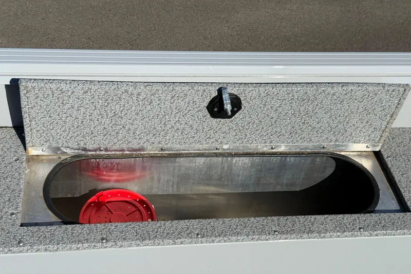 Slide: The Image of 2024 Smoker Craft Freedom 180 TL boat storage compartment with red container inside. - 21