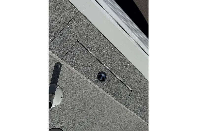 Slide: The Image of 2024 Smoker Craft Freedom 180 TL boat deck with storage compartment and textured surface. - 26