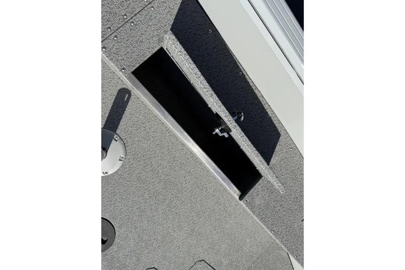 Slide: The Image of 2024 Smoker Craft Freedom 180 TL boat storage compartment with textured surface. - 27