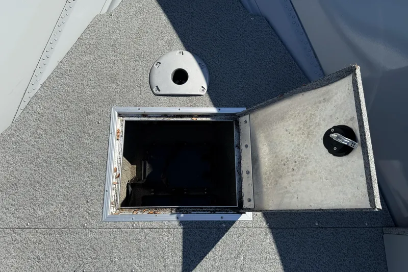Slide: The Image of Open storage compartment on 2024 Smoker Craft Freedom 180 TL boat deck. - 29