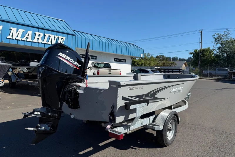 Slide: The Image of 2024 Smoker Craft Freedom 180 TL boat with Mercury engine at a marine dealership. - 3