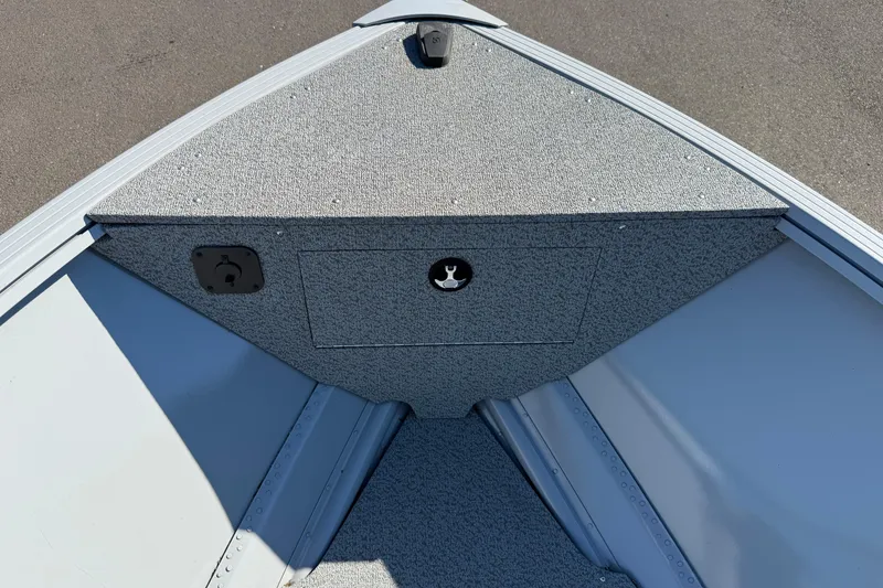 Slide: The Image of 2024 Smoker Craft Freedom 180 TL boat interior, featuring a textured bow storage compartment. - 9