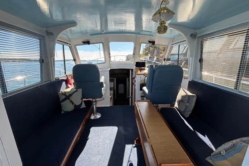 Slide: The Image of Interior of a 1985 Jarvis Newman 36 boat with blue seating and wooden accents. - 18