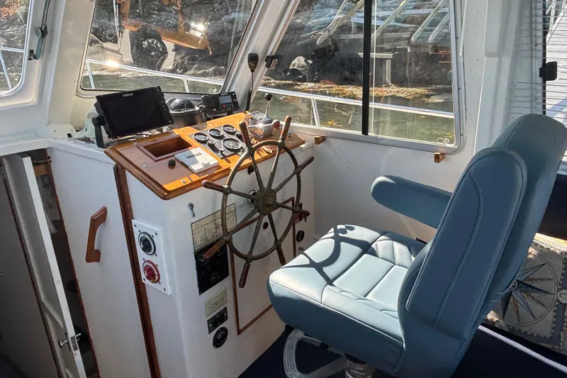Slide: The Image of Interior helm of 1985 Jarvis Newman 36 boat with steering wheel and navigation equipment. - 21