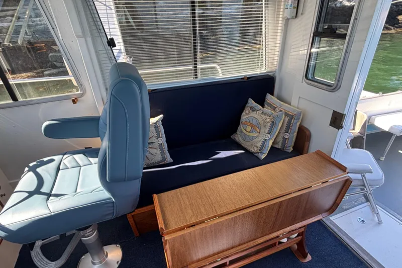 Slide: The Image of Interior of 1985 Jarvis Newman 36 boat with blue seating and decorative pillows. - 24