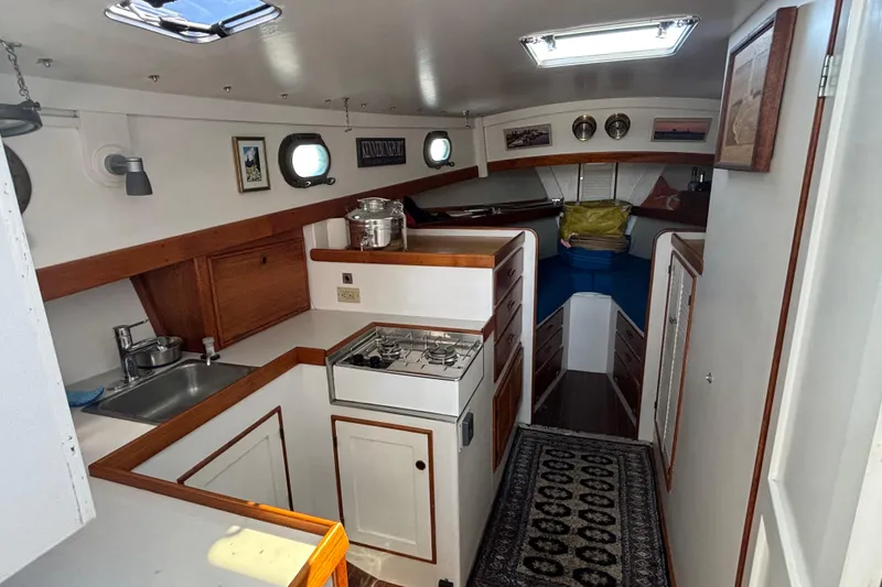 Slide: The Image of Interior of a 1985 Jarvis Newman 36 boat with kitchen and cozy sleeping area. - 26