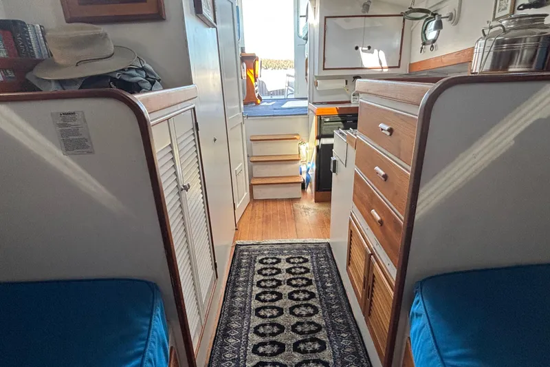 Slide: The Image of Interior of a 1985 Jarvis Newman 36 boat with wooden cabinetry and blue seating. - 34