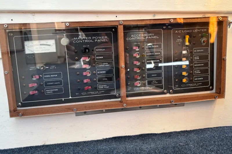 Slide: The Image of Control panel of a 1985 Jarvis Newman 36 boat with various switches and gauges. - 43