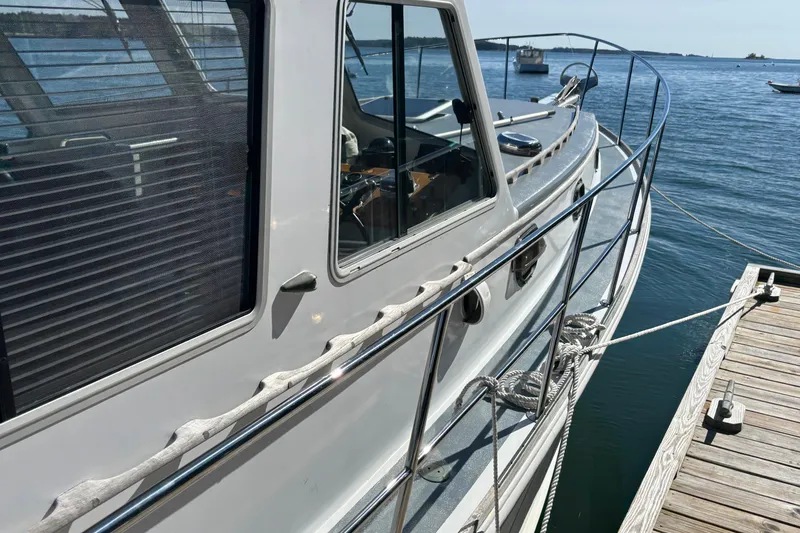 Slide: The Image of 1985 Jarvis Newman 36 boat docked, showcasing sleek design and nautical details. - 46