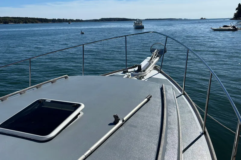 Slide: The Image of 1985 Jarvis Newman 36 boat deck overlooking calm waters and distant shoreline. - 47