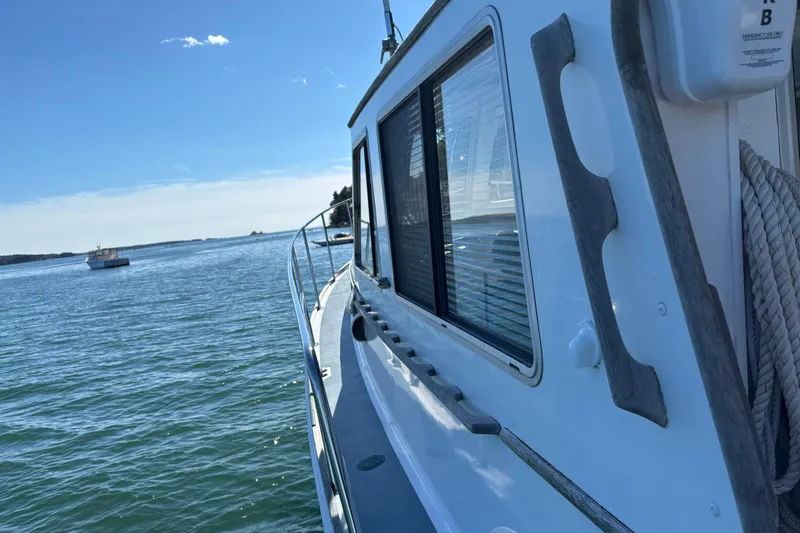 Slide: The Image of 1985 Jarvis Newman 36 boat on calm water under clear blue sky. - 52