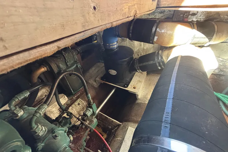 Slide: The Image of Engine compartment of a 1985 Jarvis Newman 36 boat, showing pipes and mechanical components. - 57