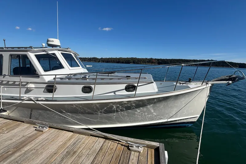 Slide: The Image of 1985 Jarvis Newman 36 boat docked on a sunny day, clear blue sky. - 6