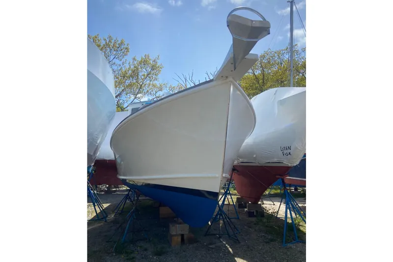 Slide: The Image of 1985 Jarvis Newman 36 boat on stands, viewed from the front, outdoors. - 61