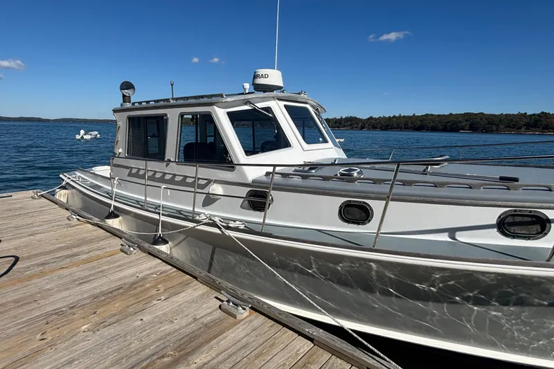 Slide: The Image of 1985 Jarvis Newman 36 boat docked on a sunny day by the water. - 7