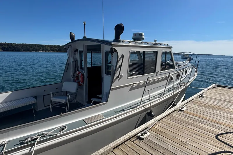Slide: The Image of 1985 Jarvis Newman 36 boat docked by the water on a sunny day. - 8