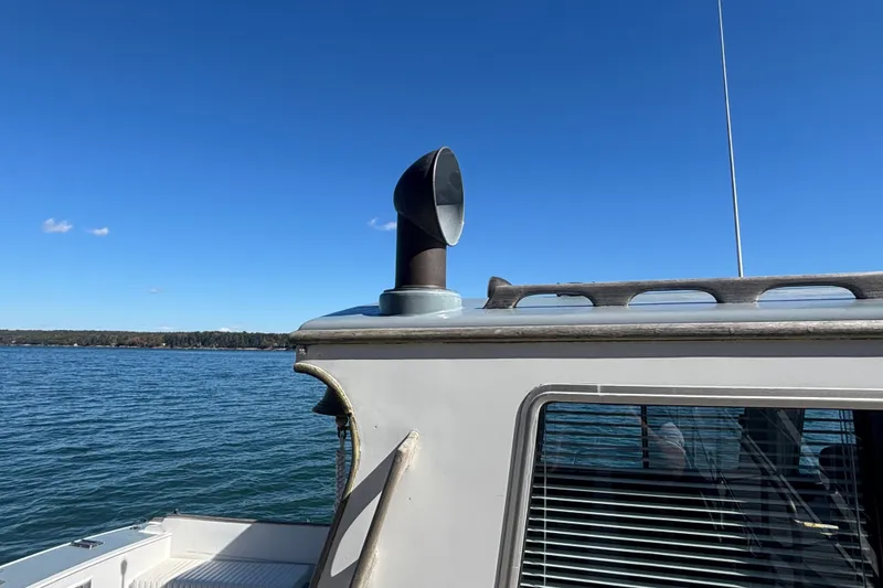 Slide: The Image of 1985 Jarvis Newman 36 boat on water, clear sky, side view. - 9