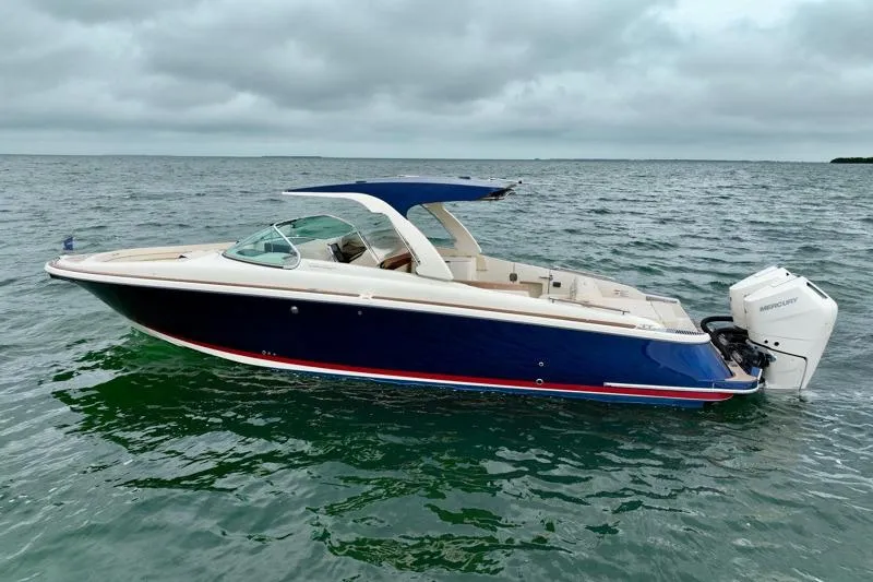 The Image of 2024 Chris-Craft Launch 35 GT boat on open water under cloudy skies. - 0