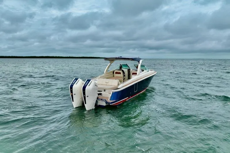 Slide: The Image of 2024 Chris-Craft Launch 35 GT boat on open water under cloudy skies. - 11