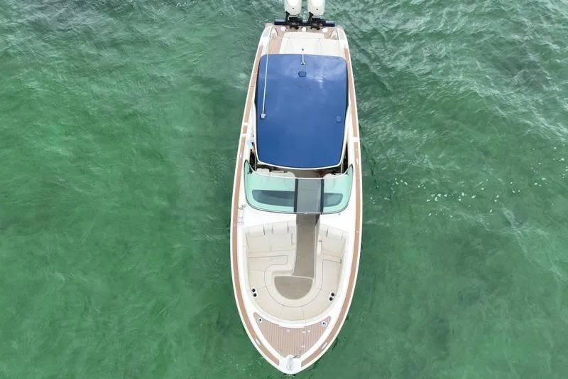 Slide: The Image of 2024 Chris-Craft Launch 35 GT boat on clear green water, aerial view. - 13