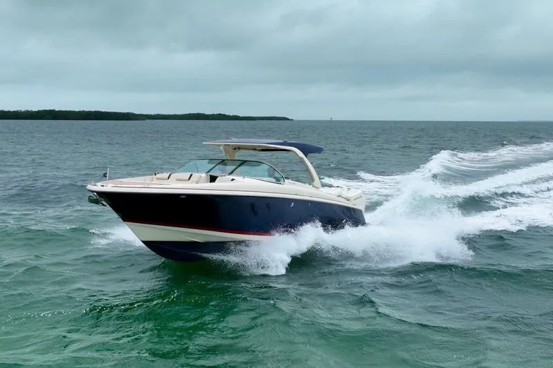 Slide: The Image of 2024 Chris-Craft Launch 35 GT cruising on open water under cloudy skies. - 15