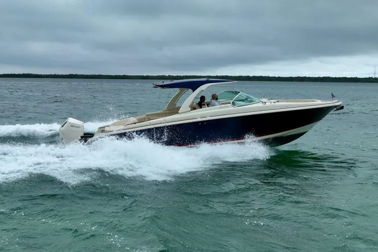 Slide: The Image of 2024 Chris-Craft Launch 35 GT cruising on open water under cloudy skies. - 16