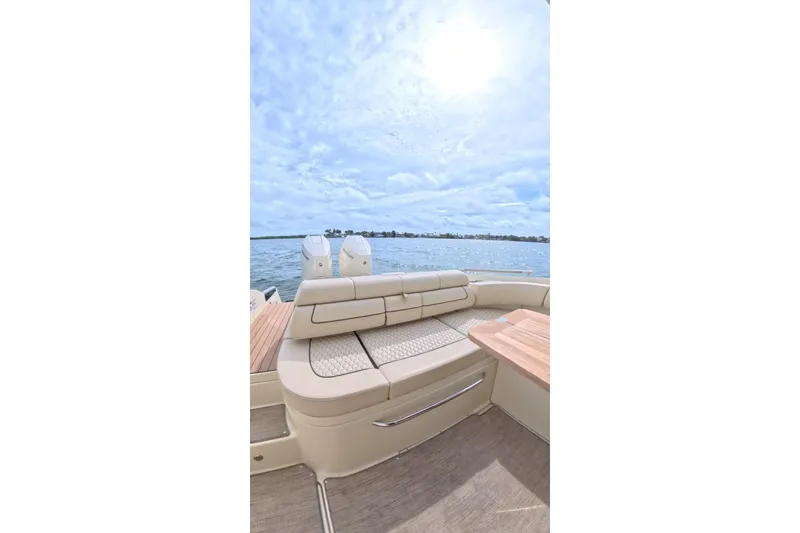 Slide: The Image of 2024 Chris-Craft Launch 35 GT boat interior with luxurious seating and scenic water view. - 19