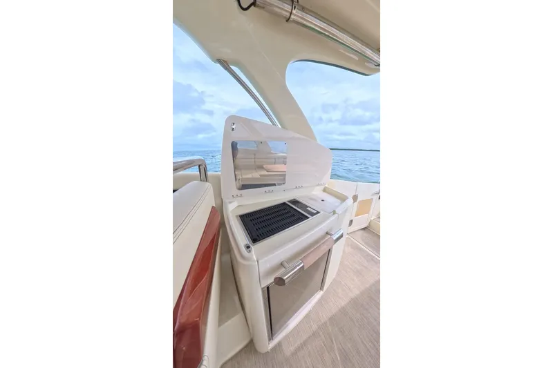 Slide: The Image of 2024 Chris-Craft Launch 35 GT boat interior with grill and ocean view. - 23