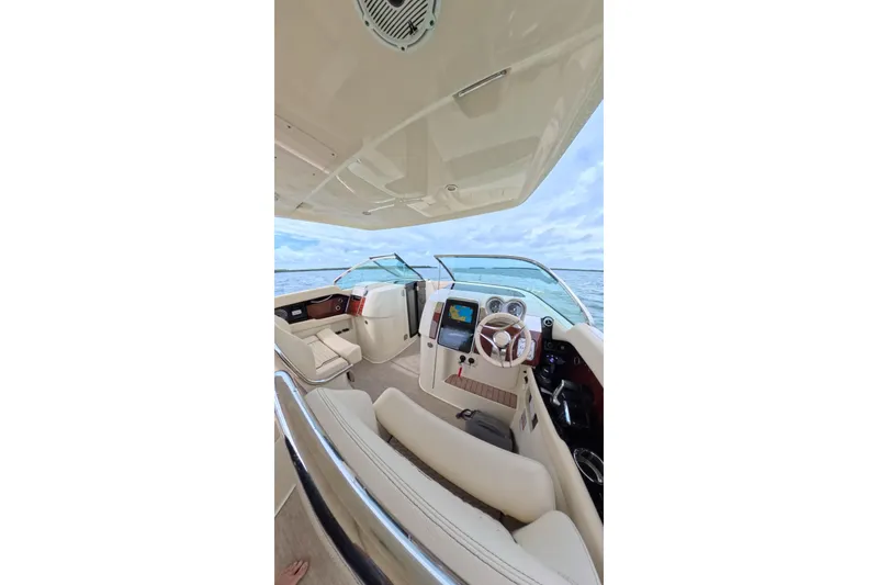 Slide: The Image of 2024 Chris-Craft Launch 35 GT interior with luxurious seating and modern dashboard on open water. - 25