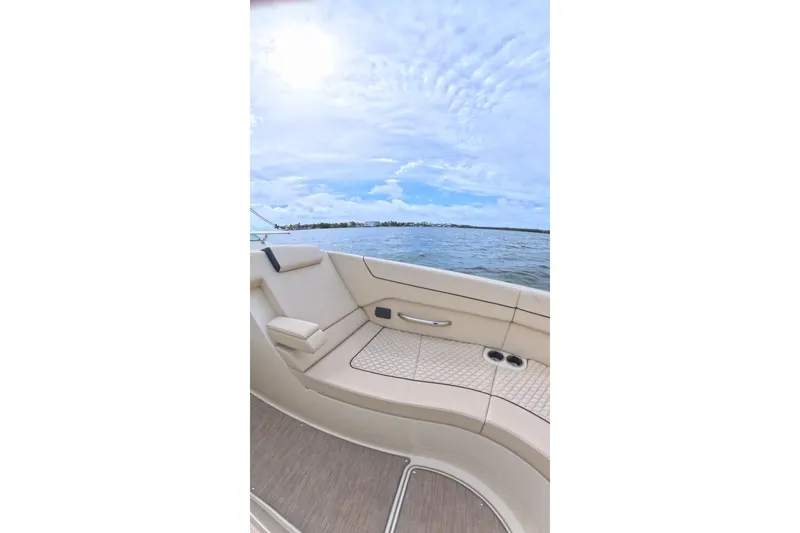 Slide: The Image of 2024 Chris-Craft Launch 35 GT boat interior with beige seating and ocean view. - 26