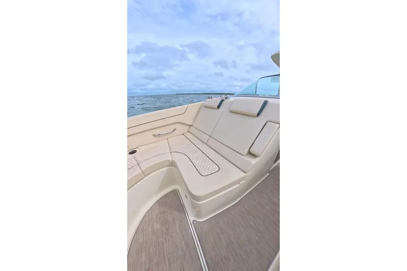 Slide: The Image of 2024 Chris-Craft Launch 35 GT boat interior with beige seating and ocean view. - 27