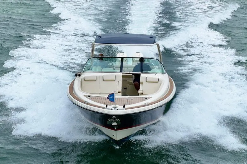 Slide: The Image of 2024 Chris-Craft Launch 35 GT cruising on open water, showcasing sleek design and performance. - 7