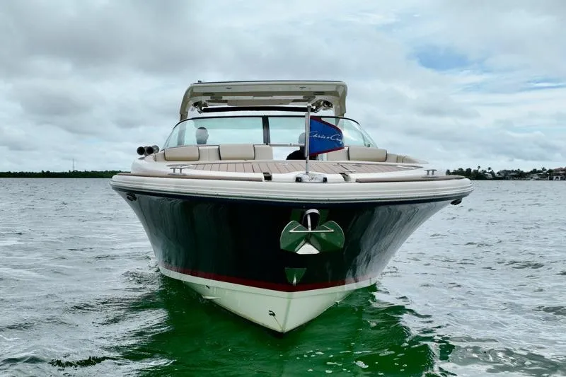 Slide: The Image of 2024 Chris-Craft Launch 35 GT boat on water, front view under cloudy sky. - 9