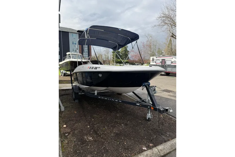Slide: The Image of 2019 Bayliner Element E16 boat on trailer with canopy in outdoor setting. - 4