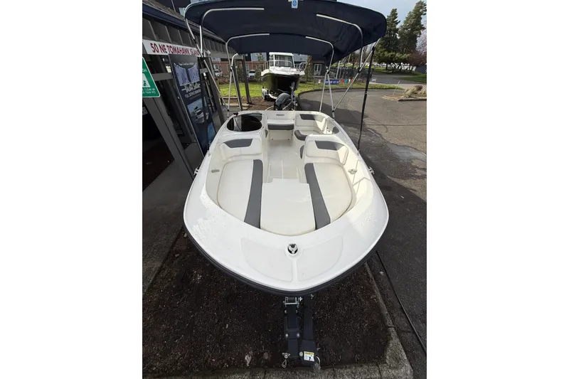 Slide: The Image of 2019 Bayliner Element E16 boat with canopy, parked outdoors. - 5