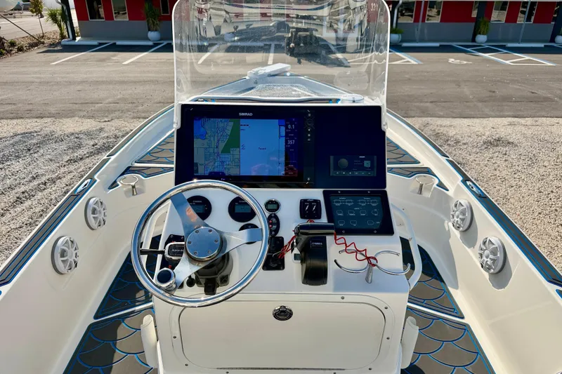 Slide: The Image of 2020 Skeeter SX230 boat dashboard with navigation system and steering wheel. - 11