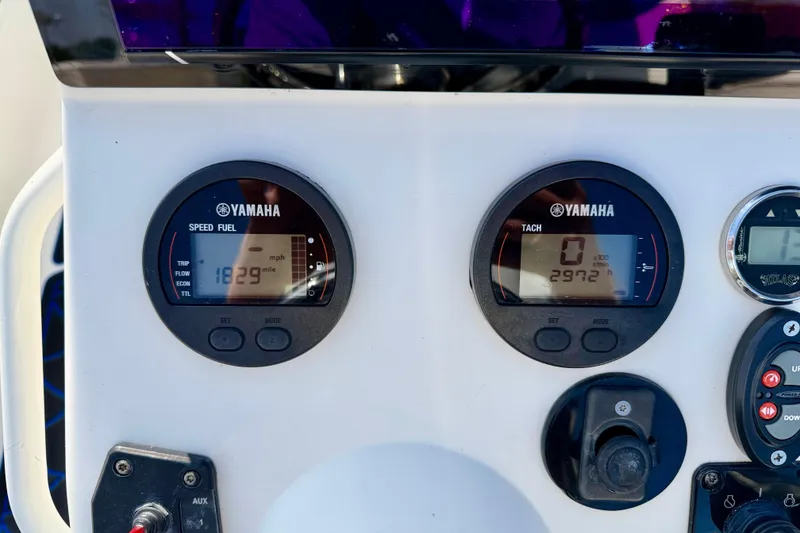 Slide: The Image of Yamaha gauges on a 2020 Skeeter SX230 boat dashboard, displaying speed and tachometer readings. - 12