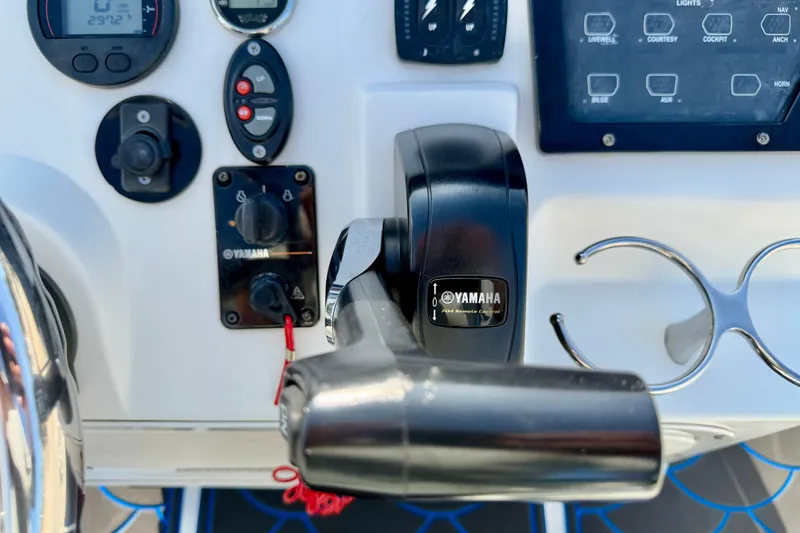 Slide: The Image of Control panel of a 2020 Skeeter SX230 boat featuring Yamaha throttle and switches. - 14