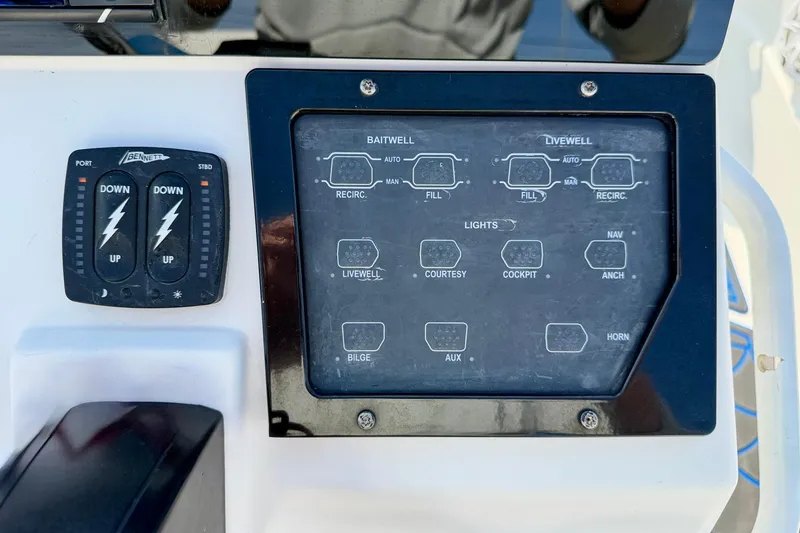 Slide: The Image of Control panel of a 2020 Skeeter SX230 boat with various switches and indicators. - 15