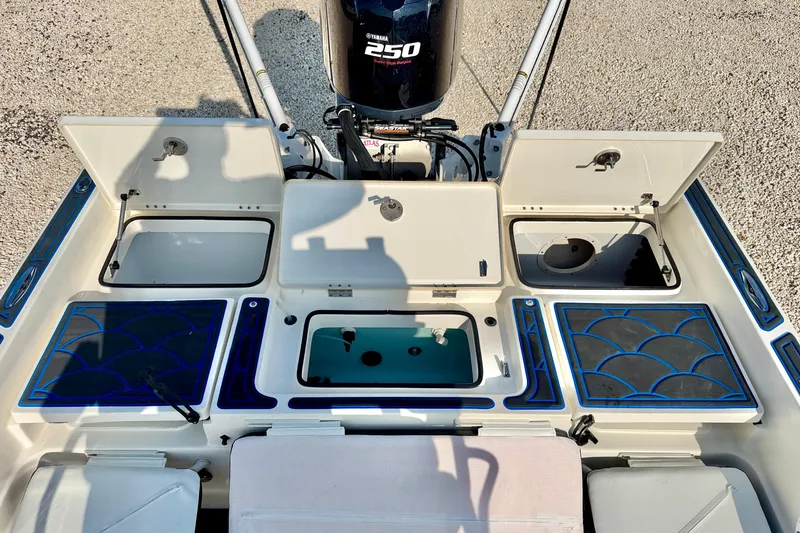Slide: The Image of 2020 Skeeter SX230 boat deck with Yamaha 250 engine, featuring storage compartments and livewell. - 22