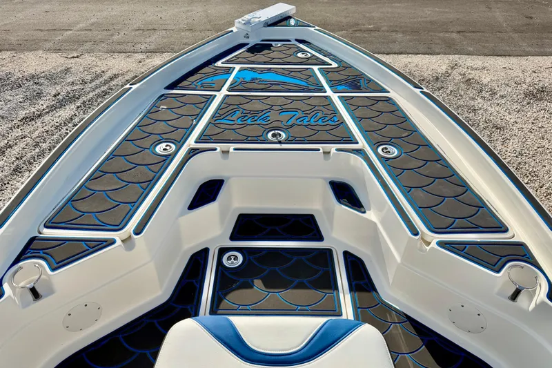 Slide: The Image of 2020 Skeeter SX230 boat deck with custom blue and black design, "Reel Tales" text. - 23