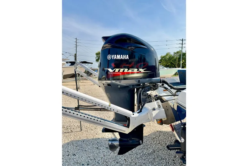 Slide: The Image of Yamaha VMAX outboard motor on a 2020 Skeeter SX230 boat, parked on gravel. - 29