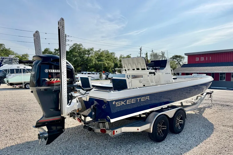 Slide: The Image of 2020 Skeeter SX230 boat with Yamaha engine on trailer in outdoor setting. - 5