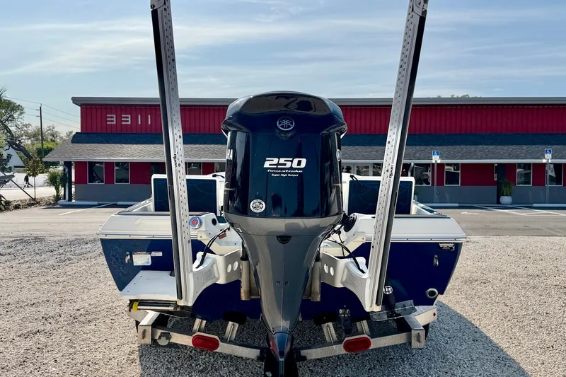 Slide: The Image of 2020 Skeeter SX230 boat with Yamaha 250 engine, parked on gravel. - 6